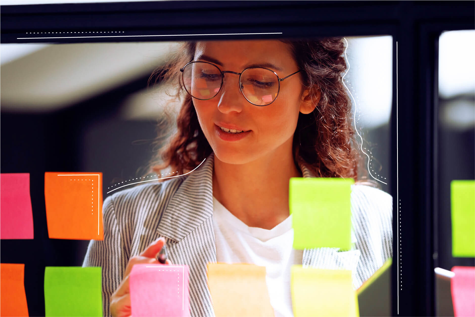 Woman sticking post-it notes on glass pane | eggheads.net