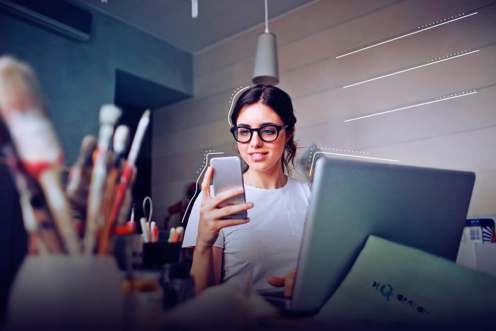 Picture of a woman on a smartphone in a creative office. | eggheads.net