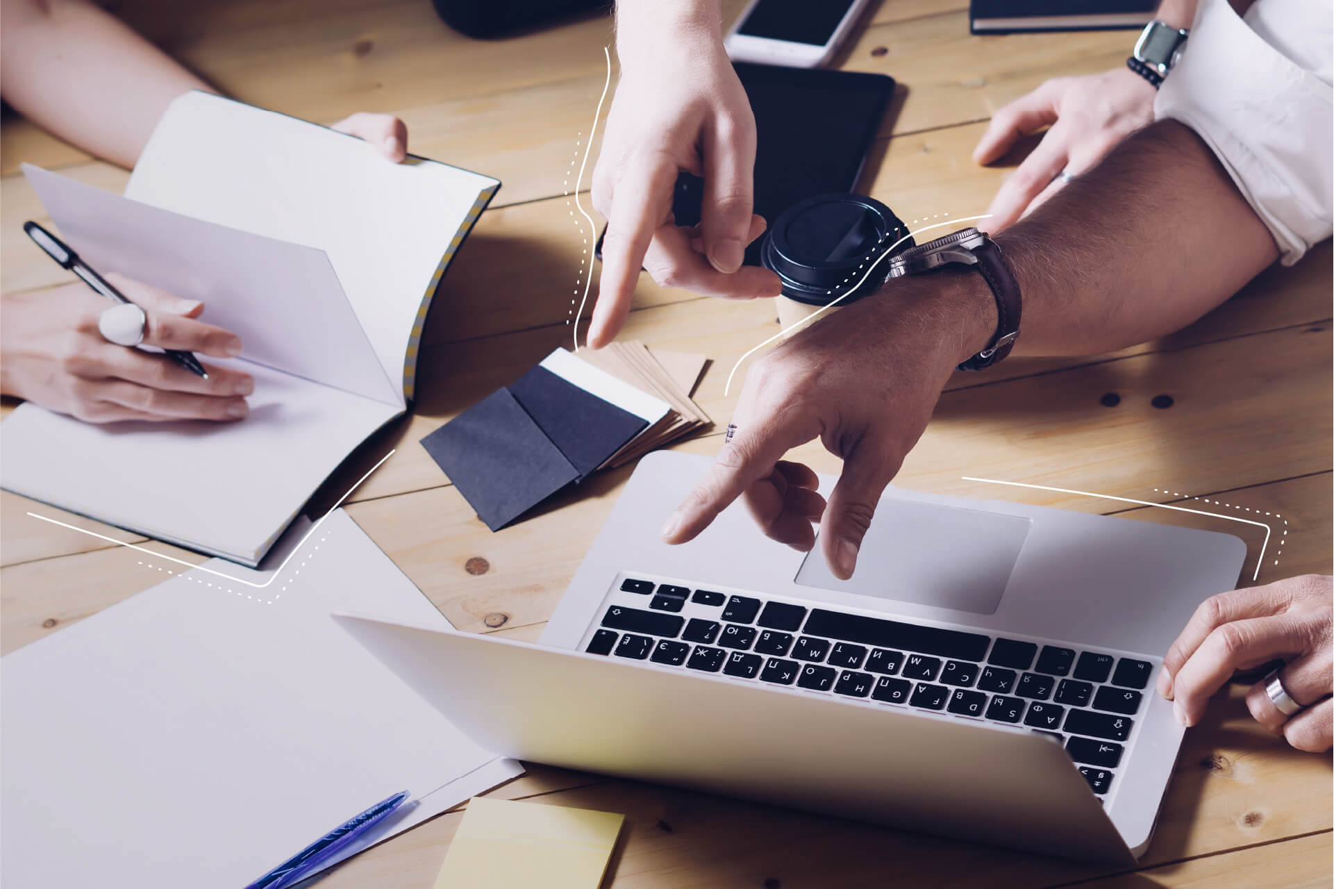 Picture of a desk showing the hands of creative people at work. | eggheads.net