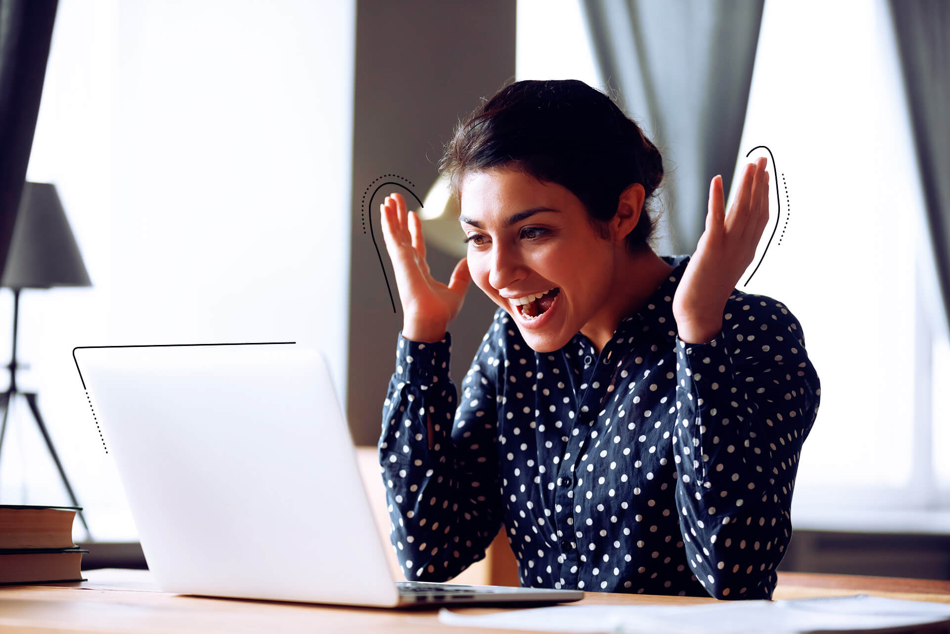 A woman who is happy while looking at a laptop | eggheads.net