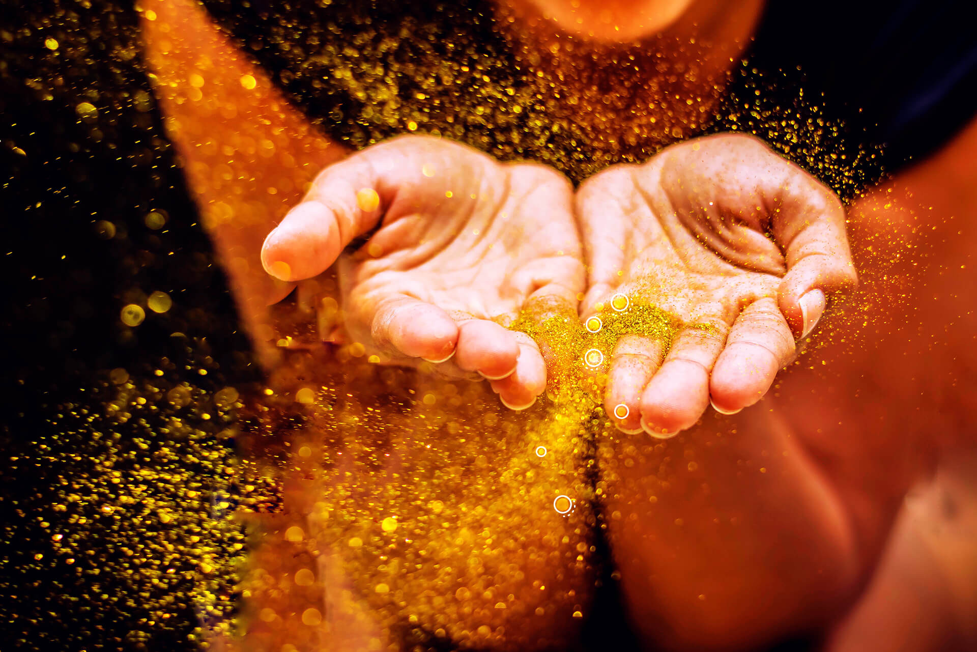 Golden confetti is blown from two hands | eggheads.net